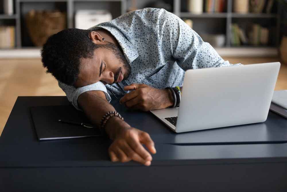 Young man sleeping on desk